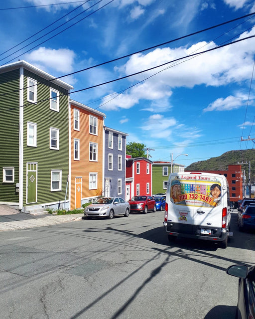 Colorful downtown St. John's row houses on street with Legend Tours tour bus