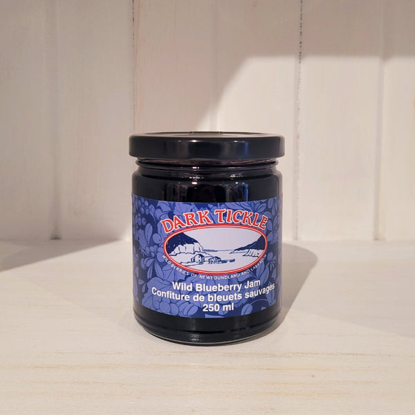 250ml jar of Dark Tickle wild blueberry jam on a wooden surface