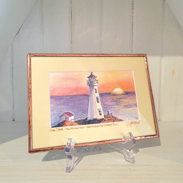 Copper Framed artwork titled "Cape Spear" by Cynthia Noel on a stand with a white background.