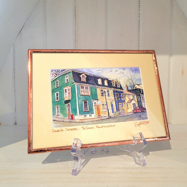 Copper Framed artwork titled "Gower at Cathedral" by Cynthia Noel on a stand with a white background.