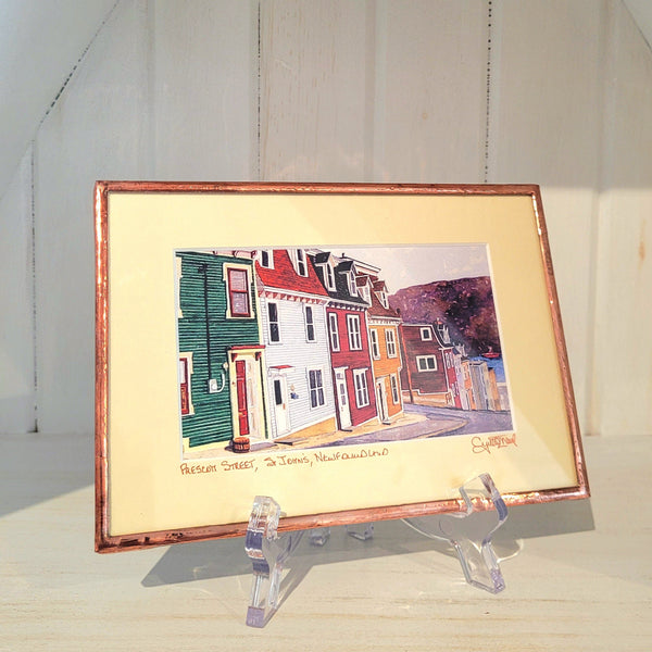 Copper Framed artwork titled "Prescott Street" by Cynthia Noel on a stand with a white background.