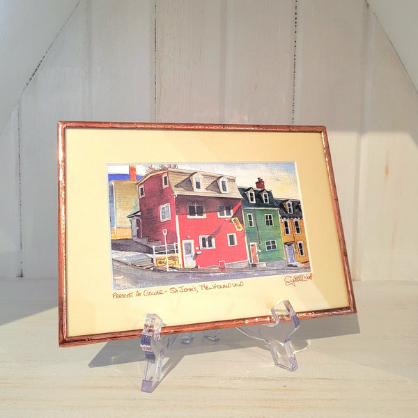 Copper Framed artwork titled "Prescott at Gower" by Cynthia Noel on a stand with a white background.
