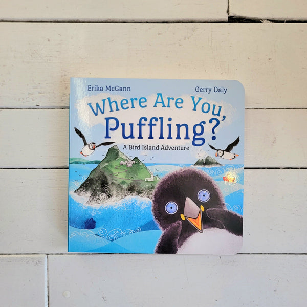 Children's boardbook titled 'Where Are You, Puffling?' on a wooden surface