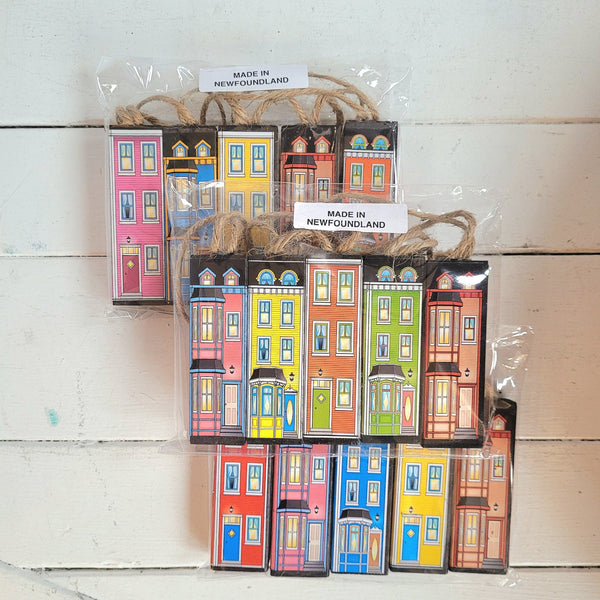 three packages of rowhouse ornaments with a variety of designs and colors