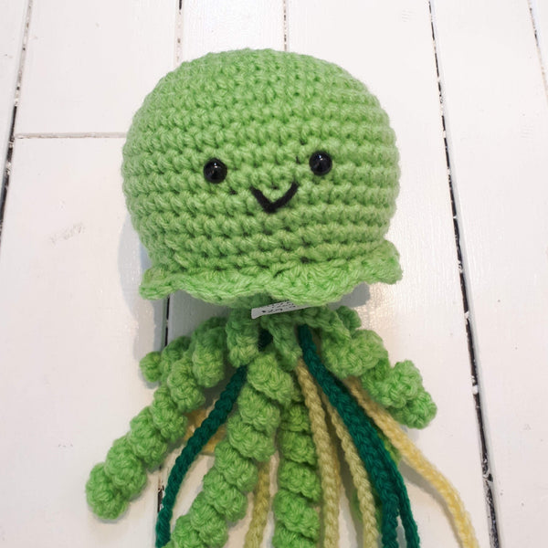 crochet plush toy jellyfish with smiley face and colourful tentacles on a white background