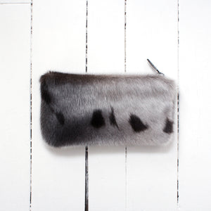 small sealskin pouch with zipper on a white background