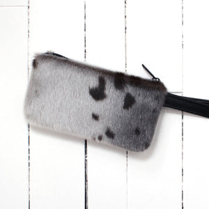 small sealskin pouch with zipper and black strap
