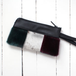 sealskin pouch designed with dark green, white, and dark red colors with zipper and strap