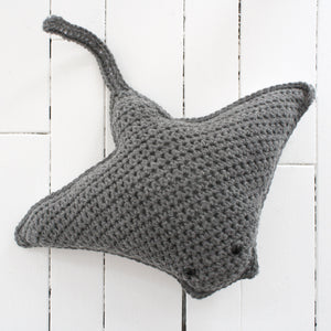crocheted stingray with two beady eyes and grey body