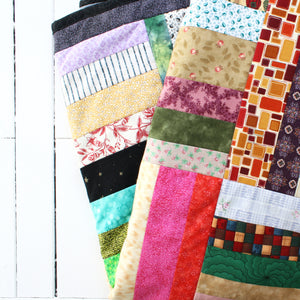 colorful quilt with strips of patchwork