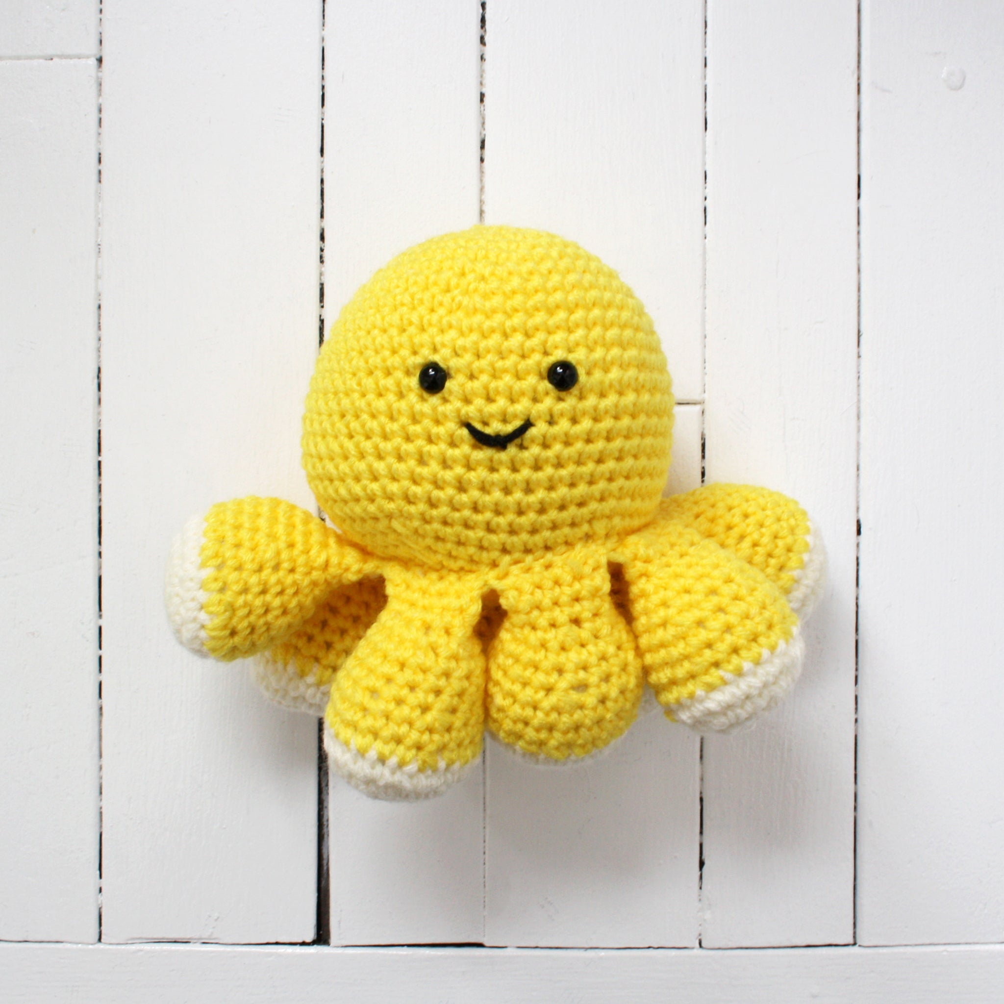 Yellow crocheted octopus plush toy made in Newfoundland.